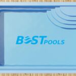 Prostokątny niebieski basen z zaokrąglonymi schodami w jednym rogu, widziany z góry.