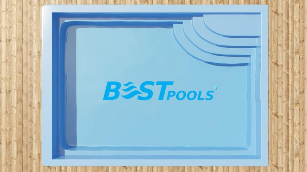 Prostokątny niebieski basen z zaokrąglonymi schodami w jednym rogu, widziany z góry.